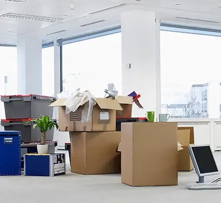 Boxes being pack in the middle of an office space