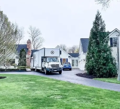 Moving truck backed into a driveway and ready to load with items