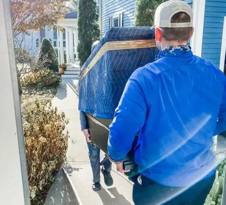 Movers carefully moving furniture