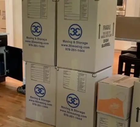 Cardboard boxes stacked in a living room
